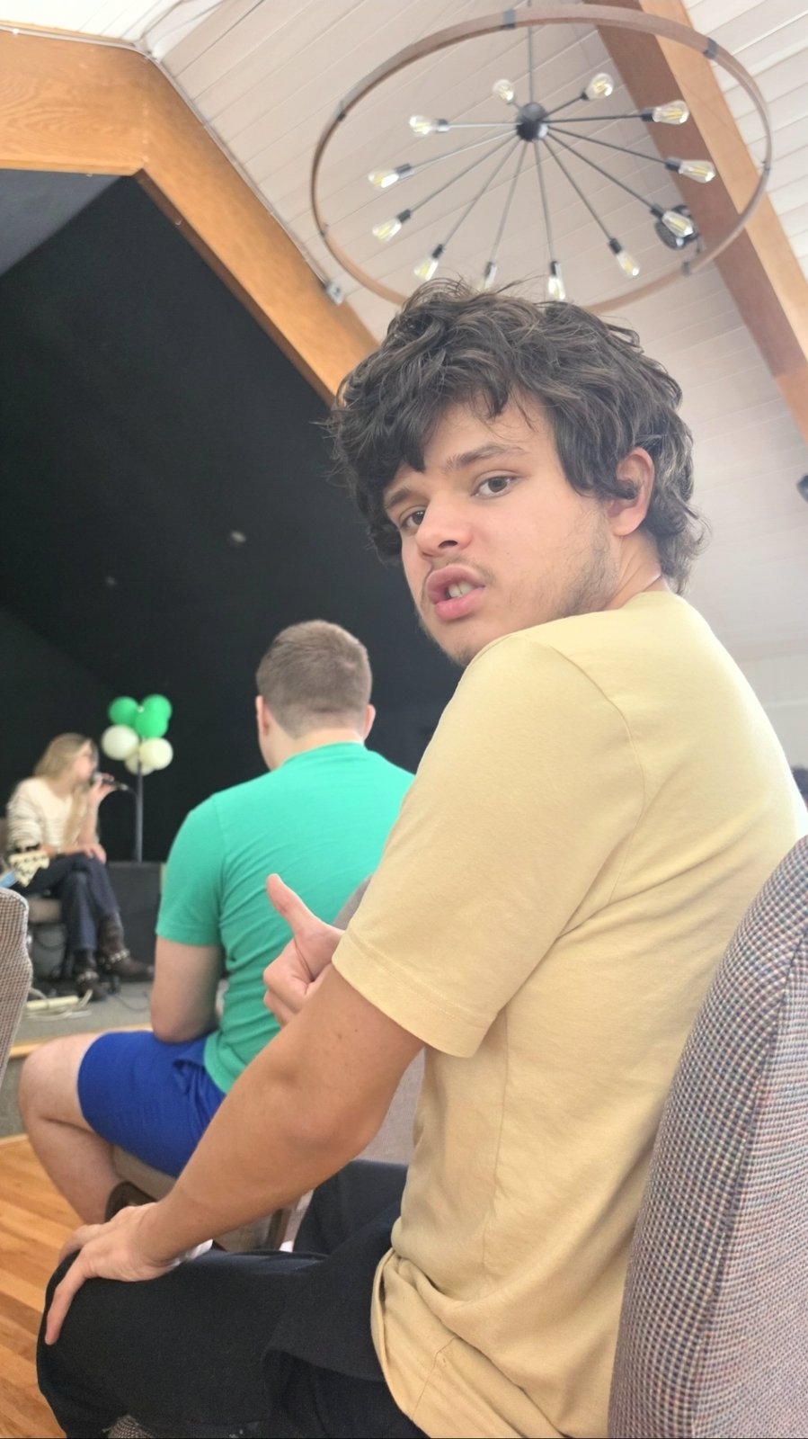A young man gives a big thumbs-up at a movehaus gathering.